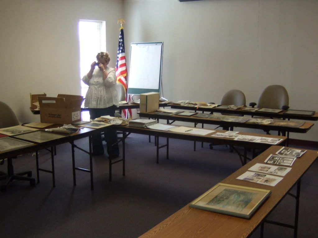 Susan McGuire takes some pictures of some of the collection spread out on tables at the park's headquarters.