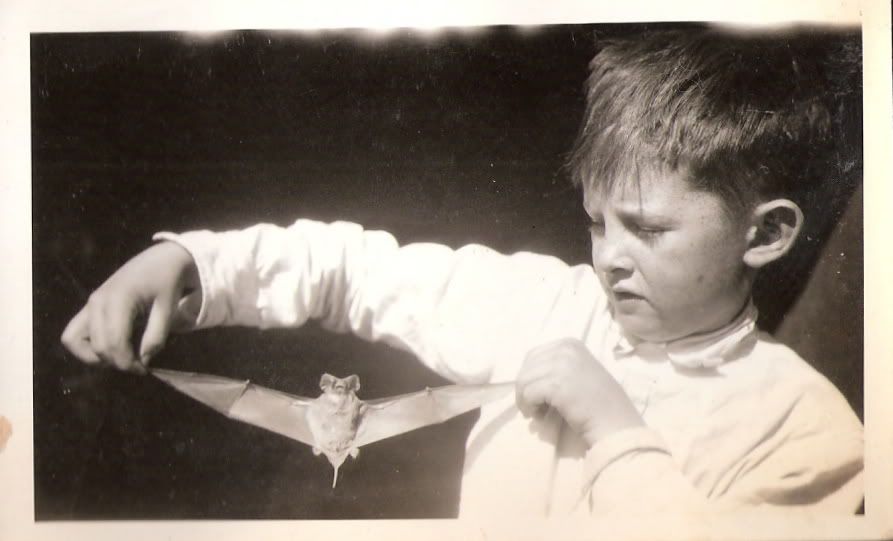 Jim White, Jr., as a child, holding a bat
